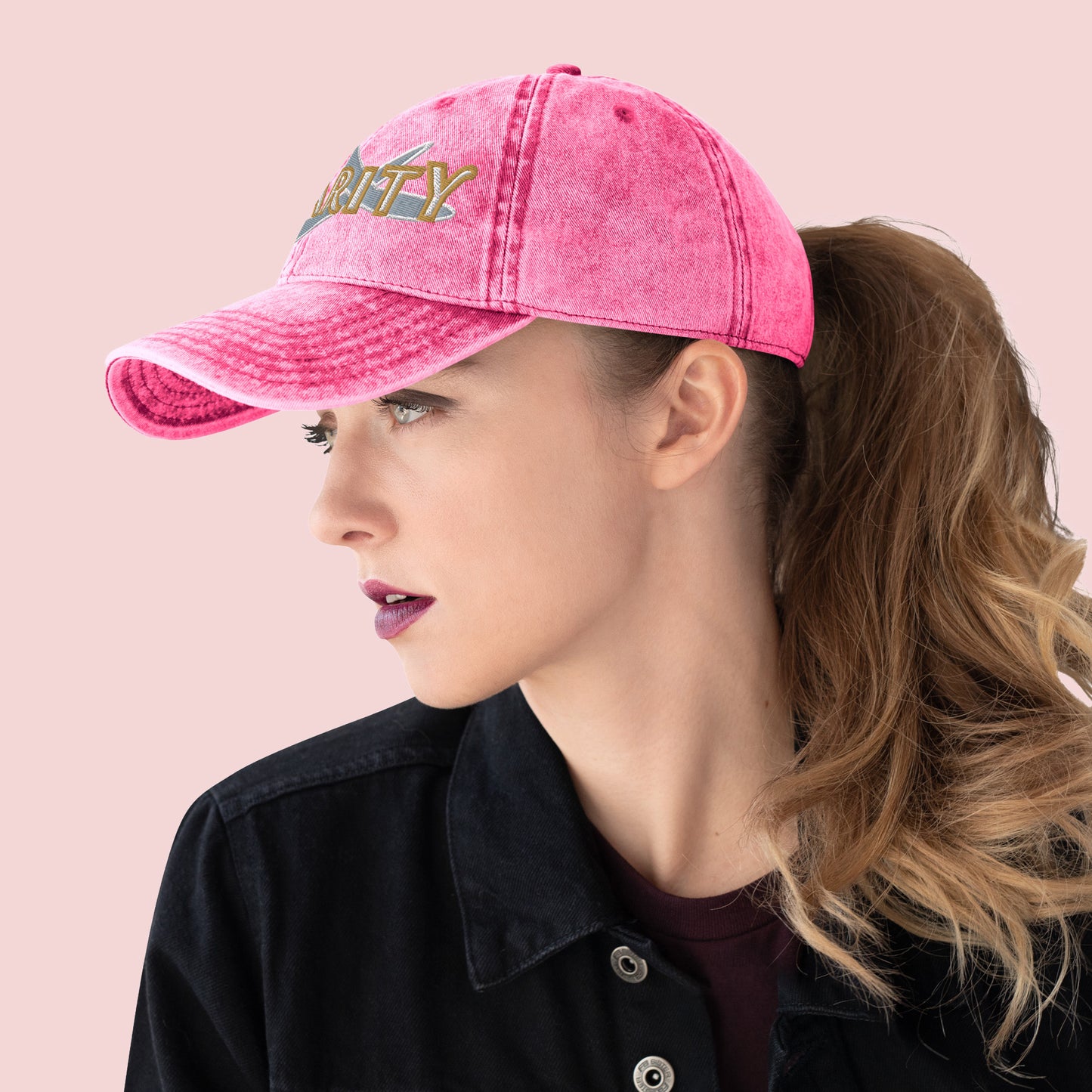 Side view of female wearing a pink cap with 'Charity' text on a pink background