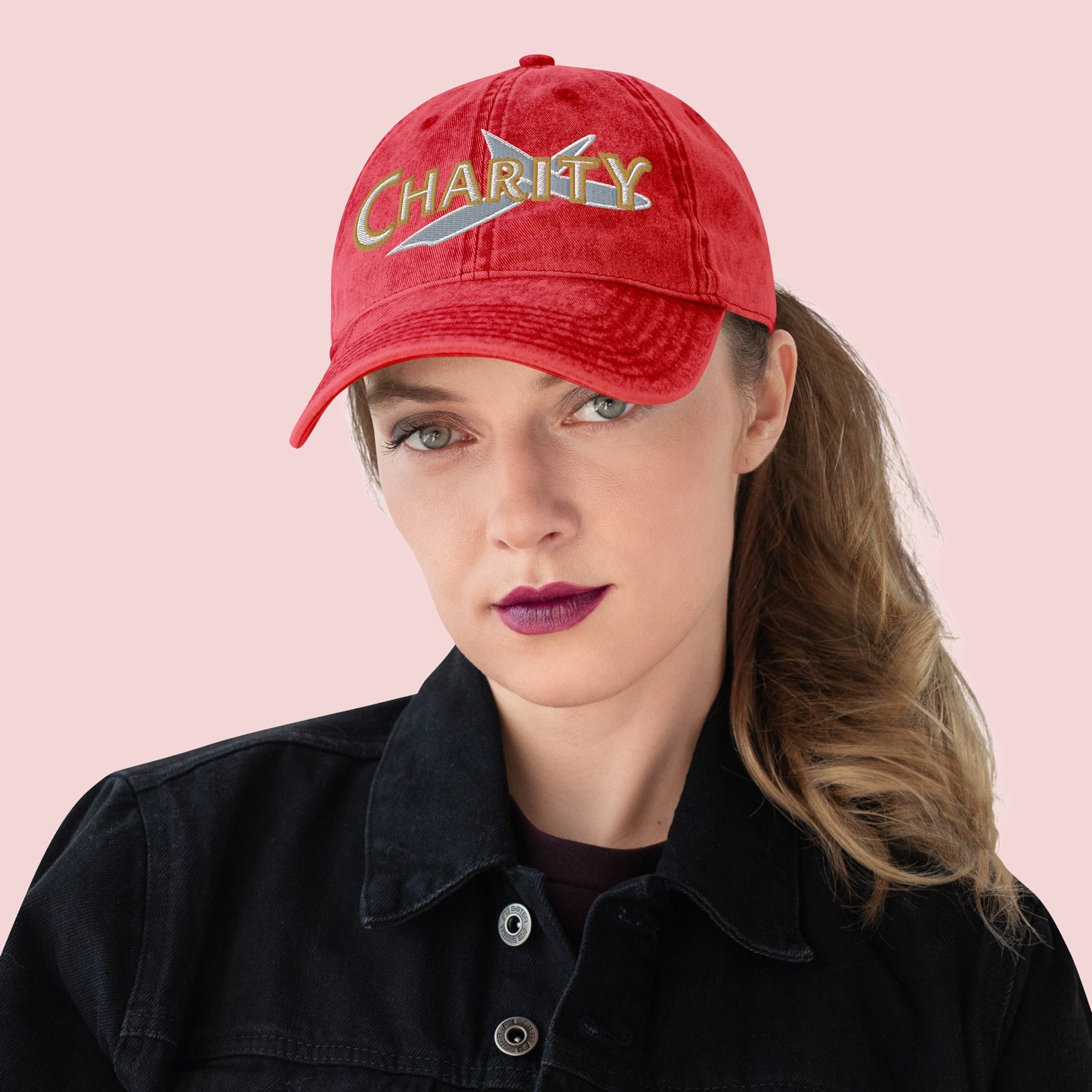Female wearing a red cap with 'Charity' text on a pink background