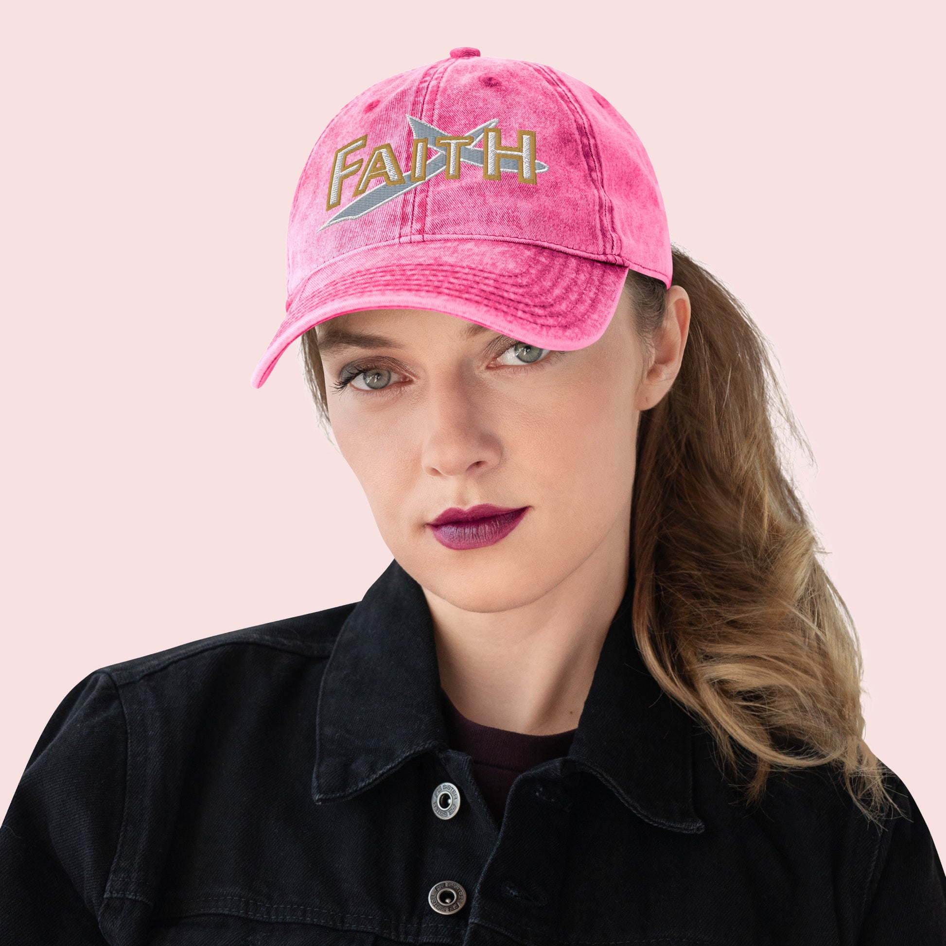 Female wearing a pink cap with 'FAITH' text on a light pink background